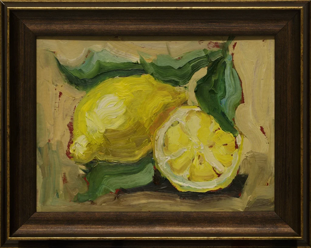 A framed painting of lemons by evening lights